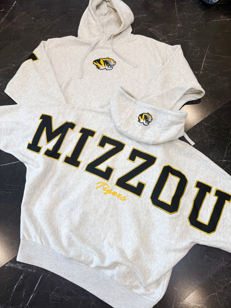 Ash grey hoodie with 'Mizzou Tigers' text and logos on a dark surface